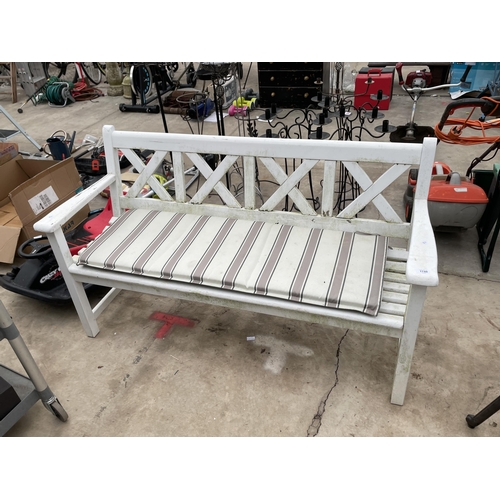 1740 - A WHITE PAINTED WOODEN SLATTED THREE SEATER GARDEN BENCH