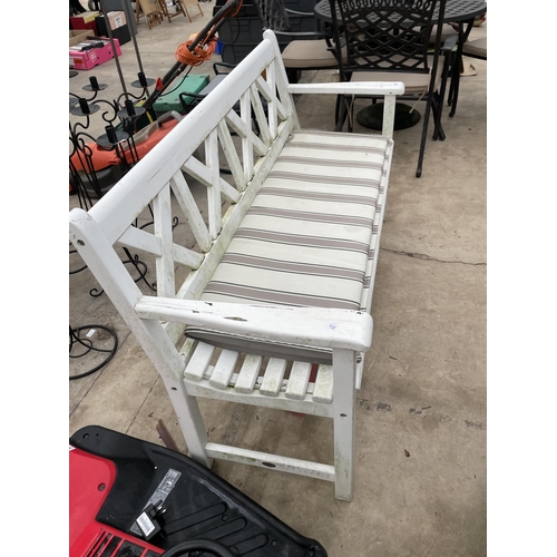 1740 - A WHITE PAINTED WOODEN SLATTED THREE SEATER GARDEN BENCH