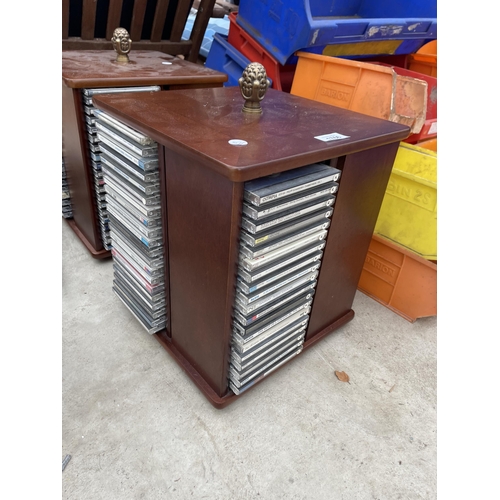 1766 - TWO REVOLVING CD RACKS WITH AN ASSORTMENT OF CDS