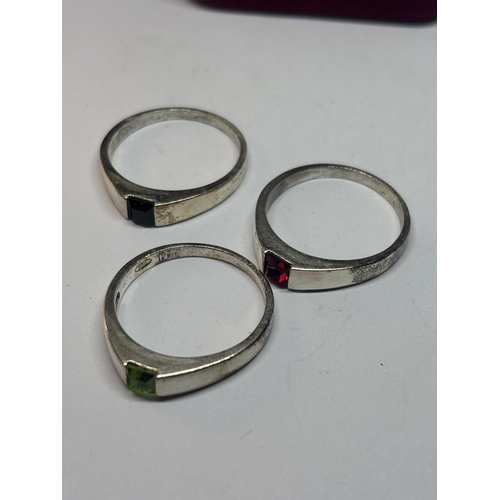 506 - A SET OF THREE SILVER RINGS WITH COLOURED STONES IN A PRESENTATION BOX