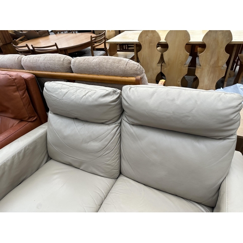 2806A - AN ITALSOFA LEATHER TWO SEATER SETTEE, ONE SECTION BEING A RECLINER