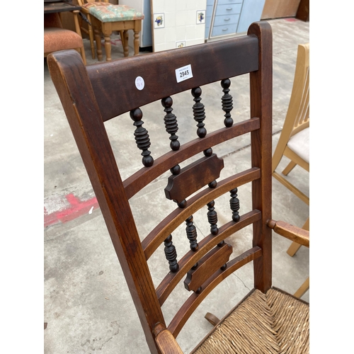 2945 - A VICTORIAN ELM ROCKING CHAIR WITH TURNED UPRIGHTS AND RUSH SEAT