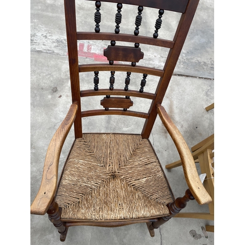 2945 - A VICTORIAN ELM ROCKING CHAIR WITH TURNED UPRIGHTS AND RUSH SEAT