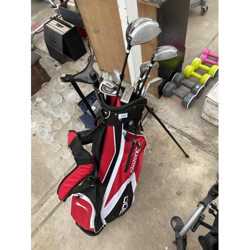 1910 - A SLAZENGER GOLF BAG AND SLAZENGER CLUBS COMPLETE WITH A TROLLEY