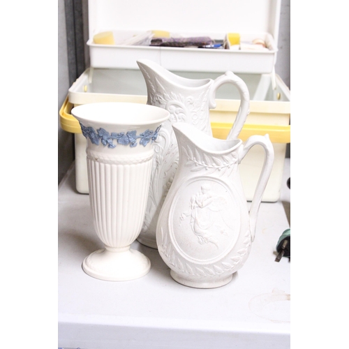 1063 - TWO TALL PARIAN WARE JUGS TOGETHER WITH A WEDGWOOD OF ETRURIA & BARLASTON VASE EMBOSSED QUEENS WARE