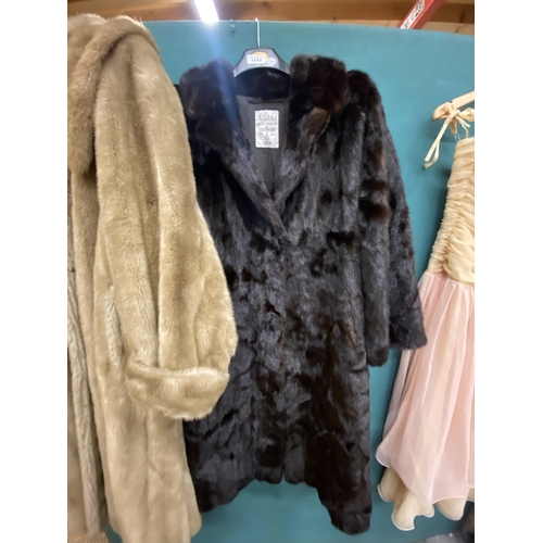 1242 - A LONG FUR COAT AND A FAUX FUR COAT