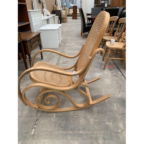 3023 - A BENTWOOD AND CANE ROCKING CHAIR