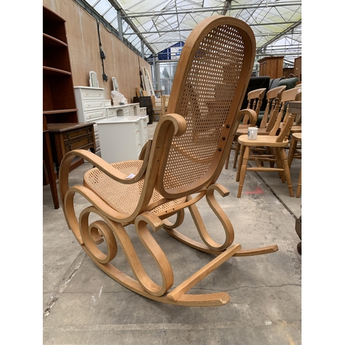 3023 - A BENTWOOD AND CANE ROCKING CHAIR