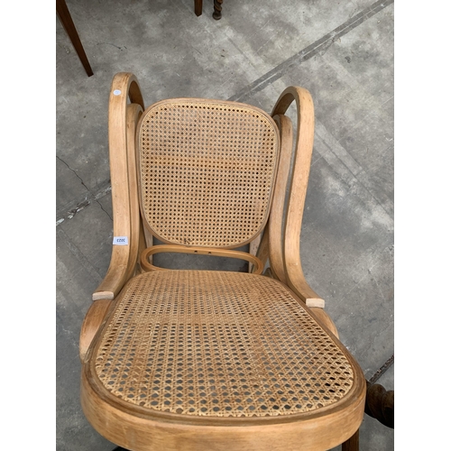 3023 - A BENTWOOD AND CANE ROCKING CHAIR