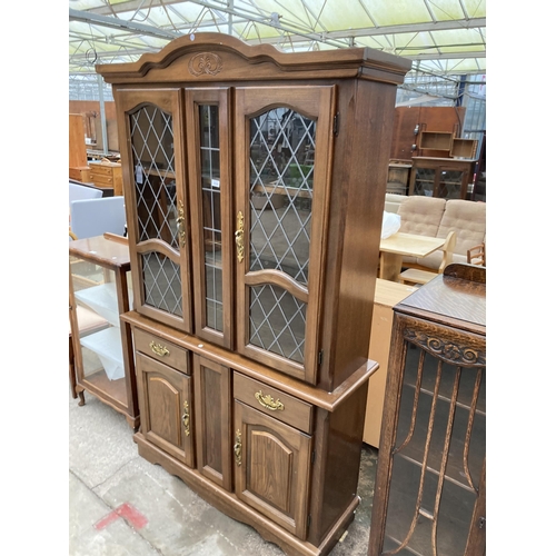 2994 - A HARDWOOD TWO DOOR CABINET ON BASE WITH GLAZED AND LEADED UPPER PORTION, 48