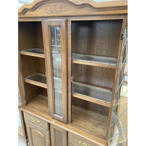 2994 - A HARDWOOD TWO DOOR CABINET ON BASE WITH GLAZED AND LEADED UPPER PORTION, 48