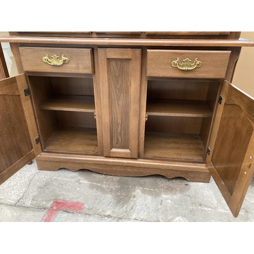 2994 - A HARDWOOD TWO DOOR CABINET ON BASE WITH GLAZED AND LEADED UPPER PORTION, 48