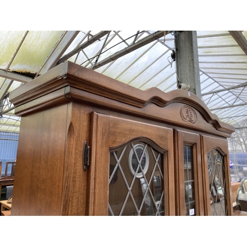 2994 - A HARDWOOD TWO DOOR CABINET ON BASE WITH GLAZED AND LEADED UPPER PORTION, 48