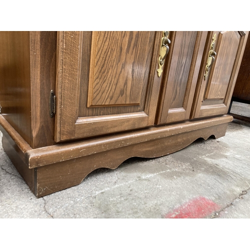 2994 - A HARDWOOD TWO DOOR CABINET ON BASE WITH GLAZED AND LEADED UPPER PORTION, 48