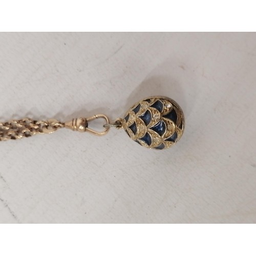 625 - A MARKED 925 SILVER FABERGE STYLE EGG ON A GOLD PLATED CHAIN