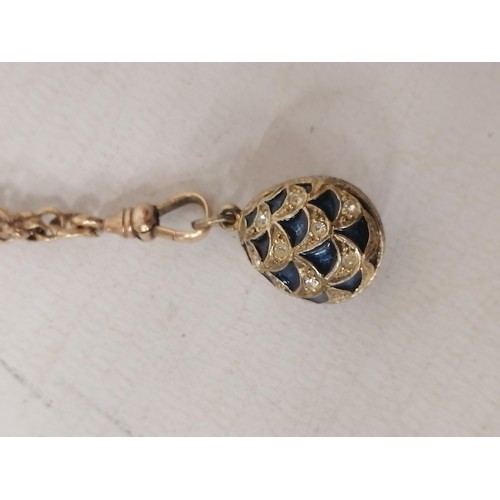 625 - A MARKED 925 SILVER FABERGE STYLE EGG ON A GOLD PLATED CHAIN