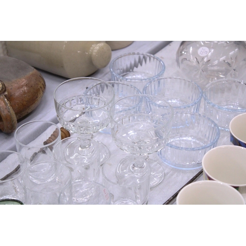 141 - A QUANTITY OF GLASSWARE TO INCLUDE A CUT GLASS DECANTER, DRINKING GLASSES, SUNDAE BOWLS, ETC.,