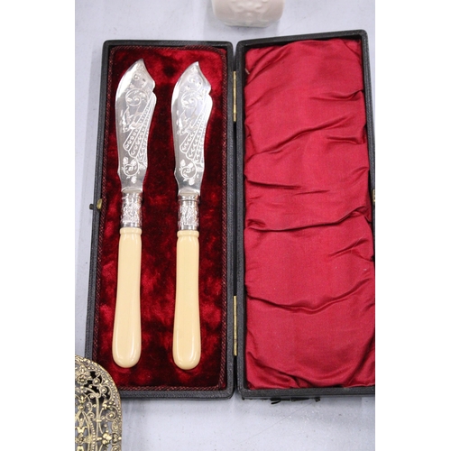 146 - A PAIR OF SILVER PLATED KNIVES IN A PRESENTATION BOX