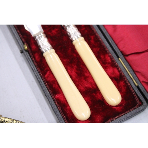 146 - A PAIR OF SILVER PLATED KNIVES IN A PRESENTATION BOX