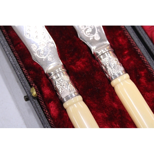 146 - A PAIR OF SILVER PLATED KNIVES IN A PRESENTATION BOX