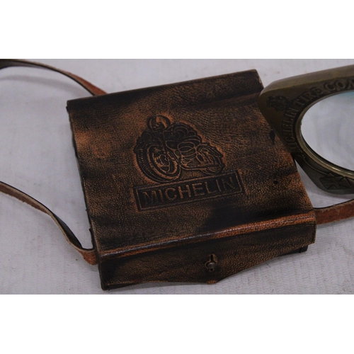 217 - A BRASS MICHELIN MAN MAGNIFYING GLASS IN A LEATHER CASE