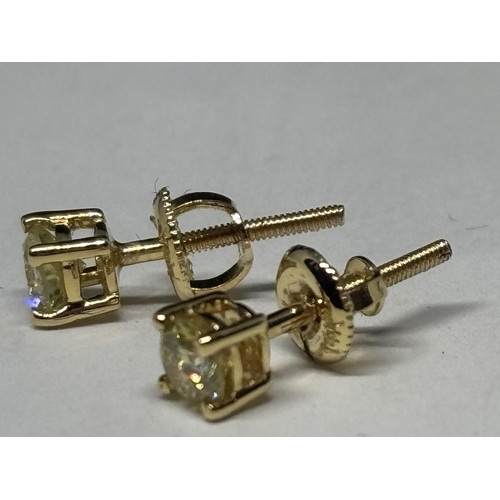 519 - A PAIR OF MARKED 14K SOLITAIRE EARRINGS WITH SCREW ON BUTTERFLY IN A PRESENTATION BOX WITH GEMOLOGY ... 