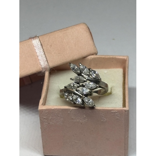 545 - A SILVER DRESS RING WITH CLEAR STONE PETAL DESIGN IN A PRESENTATION BOX