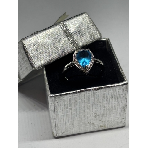 621 - A MARKED 925 SILVER RING WITH A TEARDROP BLUE TOPAZ STONE IN A PRESENTATION BOX