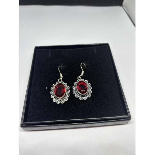 635 - A PAIR OF MARKED 925 SILVER EARRINGS WITH RED STONES IN A PRESENTATION BOX