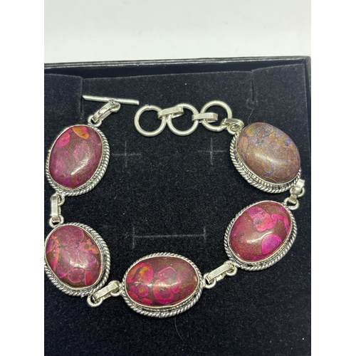 638 - A MARKED 925 SILVER BRACELET WITH PURPLE AND RED STONES IN A PRESENTATION BOX