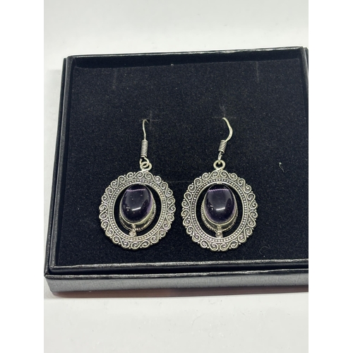 640 - A APAIR OF MARKED 925 SILVER EARRINGS WITH PURPLE STONES IN A PRESENTATION BOX