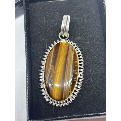 643 - A MARKED 925 SILVER TIGER EYE PENDANT IN A PRESENTATION BOX