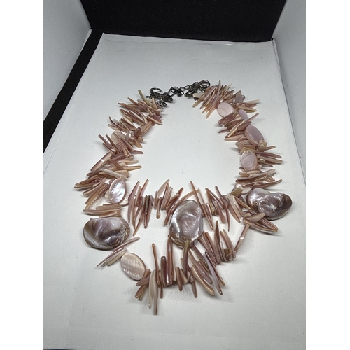 664 - A DOUBLE STRAND PINK SHELL NECKLACE WITH LIZARD DESIGN CLASP