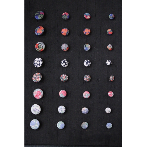 935 - A THIRTY TWO ORNATE BUTTON DISPLAY FROM LIBERTY'S EMPORIUM, LONDON