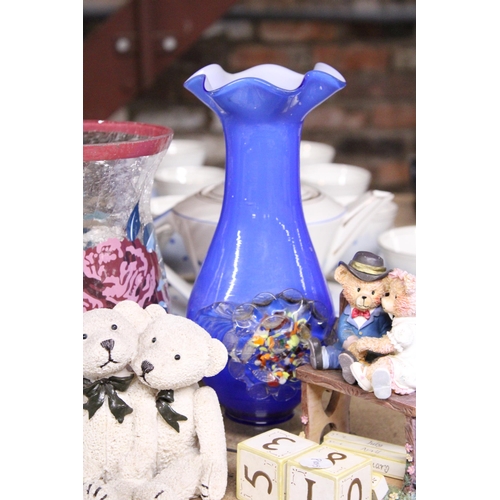 1029 - A VINTAGE BLUE ART GLASS VASE WITH EMBOSSED FLORAL DECORATION AND FLUTED RIM, TEDDY FIGURES, ETC,