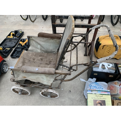 2036 - A VINTAGE METAL AND WOODEN FOLDING WHEELCHAIR