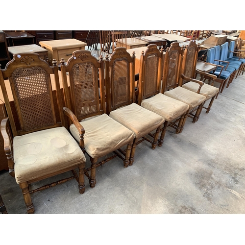 2557 - A SET OF SIX AMERICAN STYLE HARDWOOD DINING CHAIRS WITH SPLIT CANE BACKS, TWO BEING CARVERS