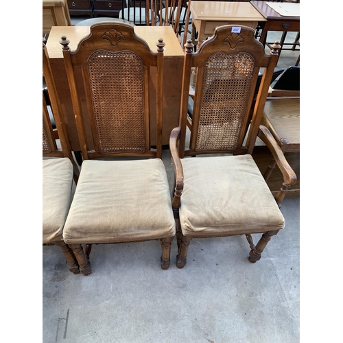 2557 - A SET OF SIX AMERICAN STYLE HARDWOOD DINING CHAIRS WITH SPLIT CANE BACKS, TWO BEING CARVERS