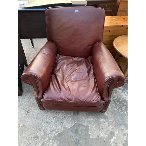 2568 - A LEATHER EASY CHAIR WITH BUN FRONT FEET