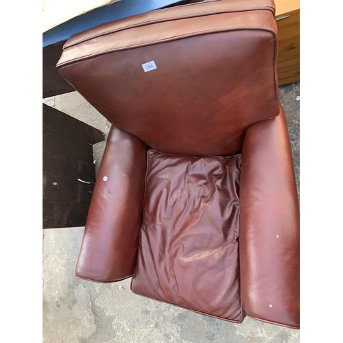 2568 - A LEATHER EASY CHAIR WITH BUN FRONT FEET