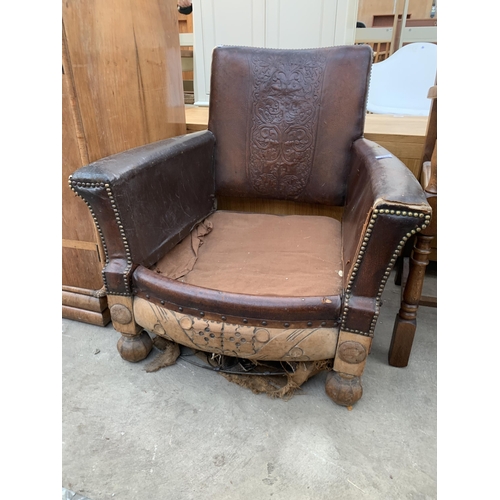 2620 - AN EARLY 20TH CENTURY LEATHER STUDDED FIRESIDE CHAIR