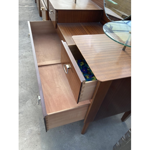 2780 - A RETRO LEBUS STEPPED DRESSING TABLE ENCLOSING THREE DRAWERS AND TWO GLASS SHELVES, 43