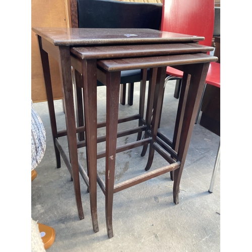 2838 - A NEST OF MAHOGANY TABLES