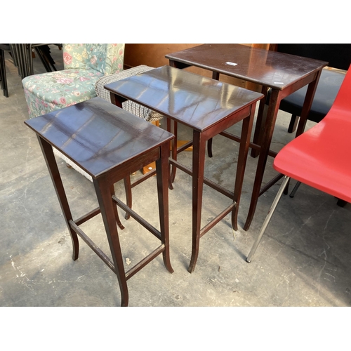 2838 - A NEST OF MAHOGANY TABLES