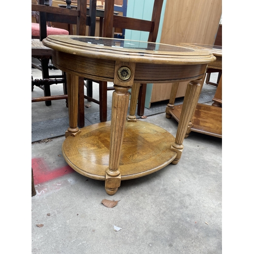 2926 - A HARDWOOD HEXAGONAL TWO TIER LAMP TABLE WITH INSET GLASS TOP AND A SIMILAR OVAL TABLE