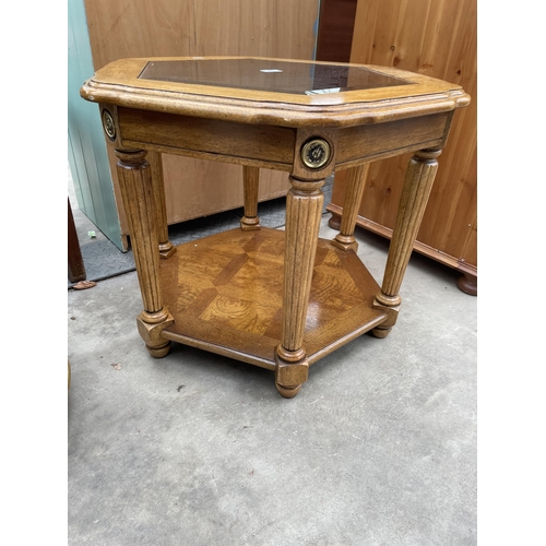 2926 - A HARDWOOD HEXAGONAL TWO TIER LAMP TABLE WITH INSET GLASS TOP AND A SIMILAR OVAL TABLE