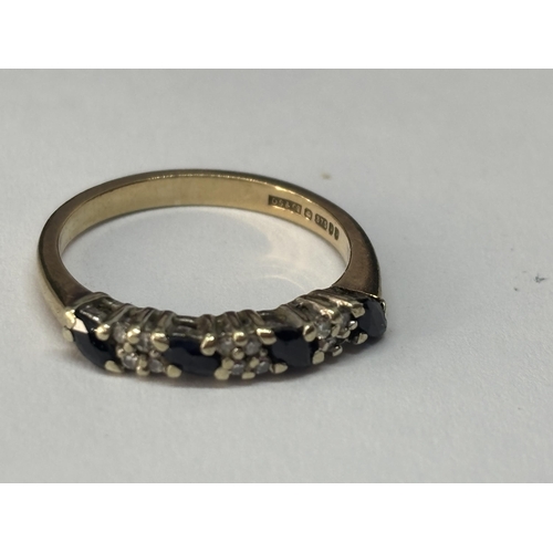 513 - A MARKED 9 CARAT GOLD RING WITH FOUR SAPPHIRES AND DIAMONDS