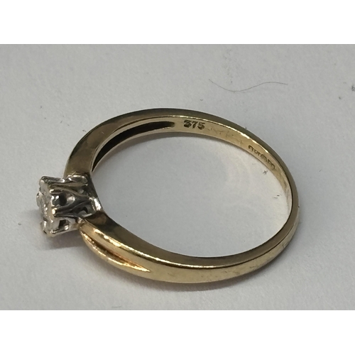 514 - A MARKED 9 CARAT GOLD WITH DIAMOND RING