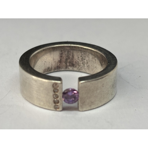 544 - A HEAVY MARKED SILVER SIGNET RING WITH PURPLE STONE