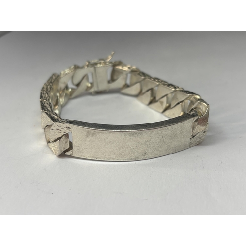 557 - A HEAVY HALLMARKED LONDON SILVER BARK DESIGN ID BRACELET